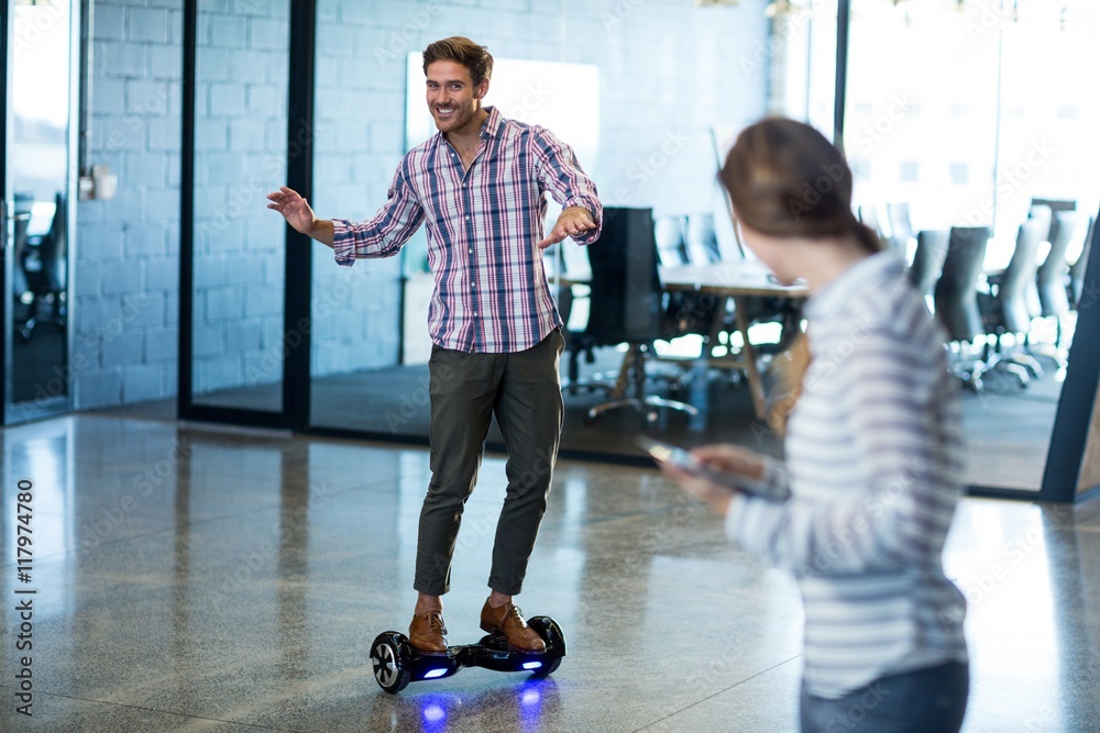 Graphic designer standing on hoverboard