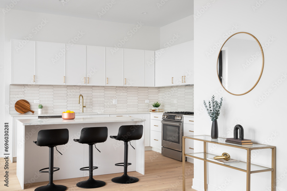 A kitchen with black bar stool