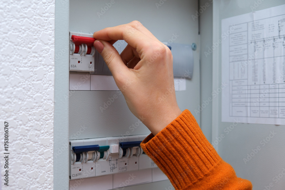 Woman trying to find electric faults in the home