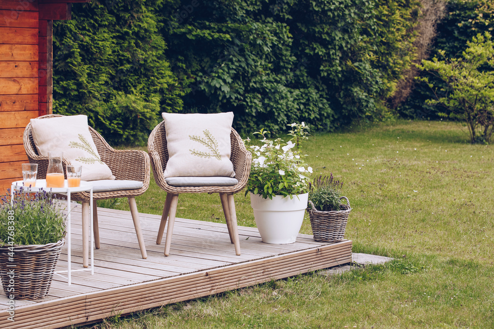 2 woven garden chairs outside in the garden