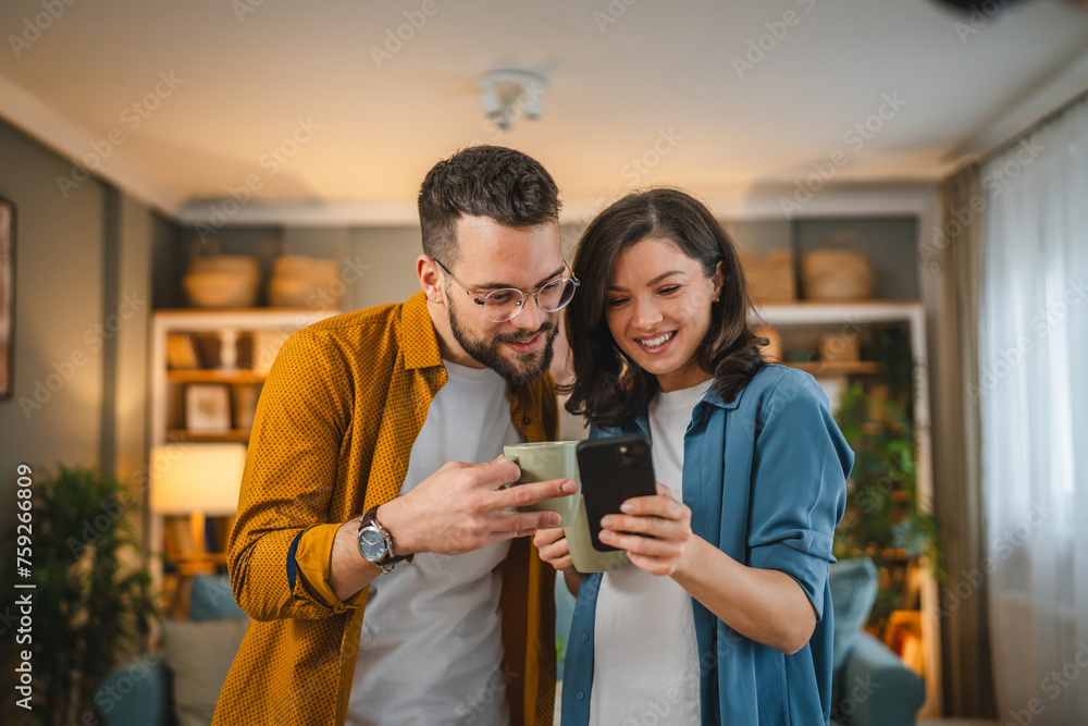 A man and woman use mobile phone search internet for the best iPhone insurance