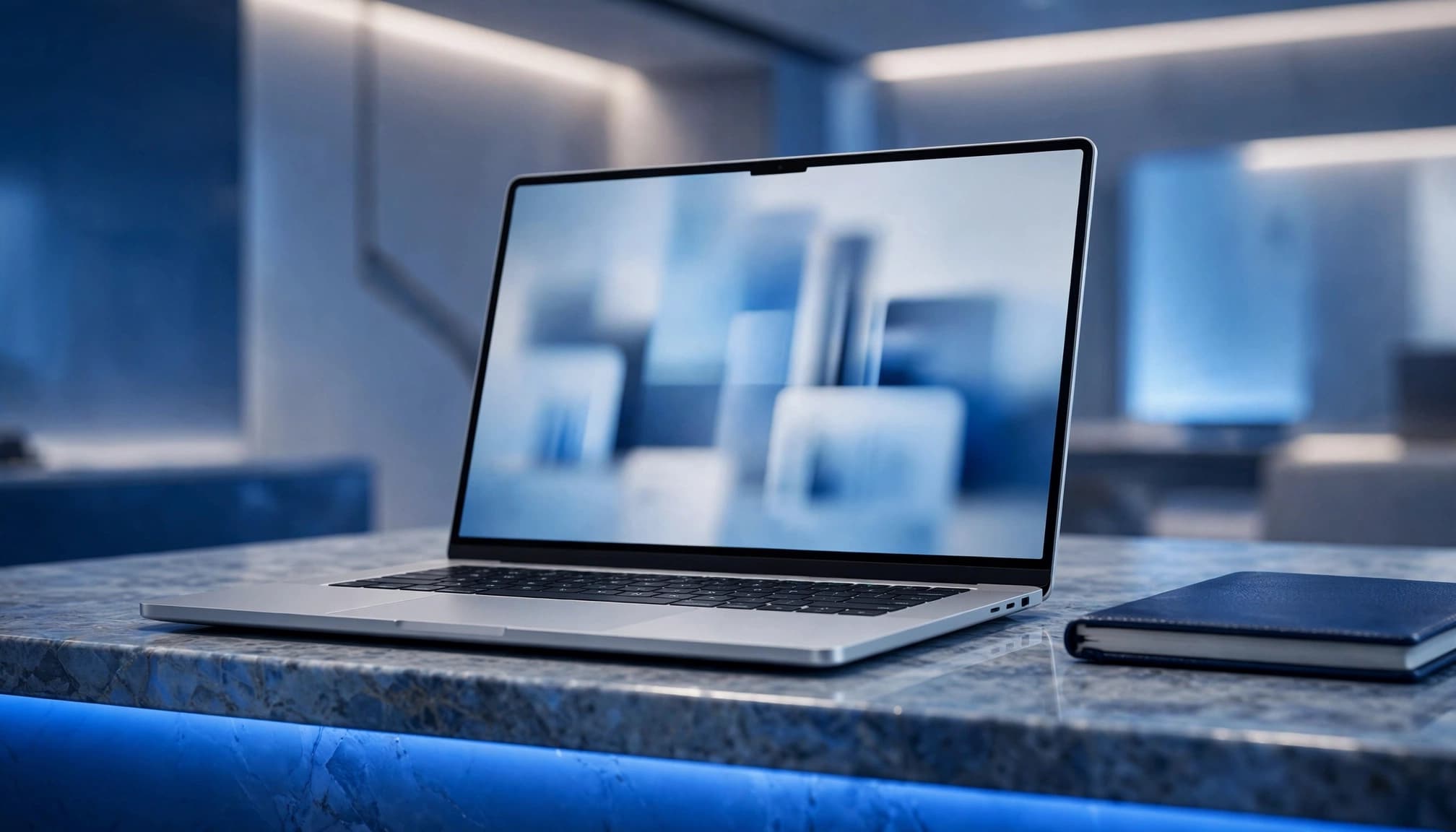 Premium laptop showing a blurred comparison screen on a blue-accented desk beside a leather notebook.