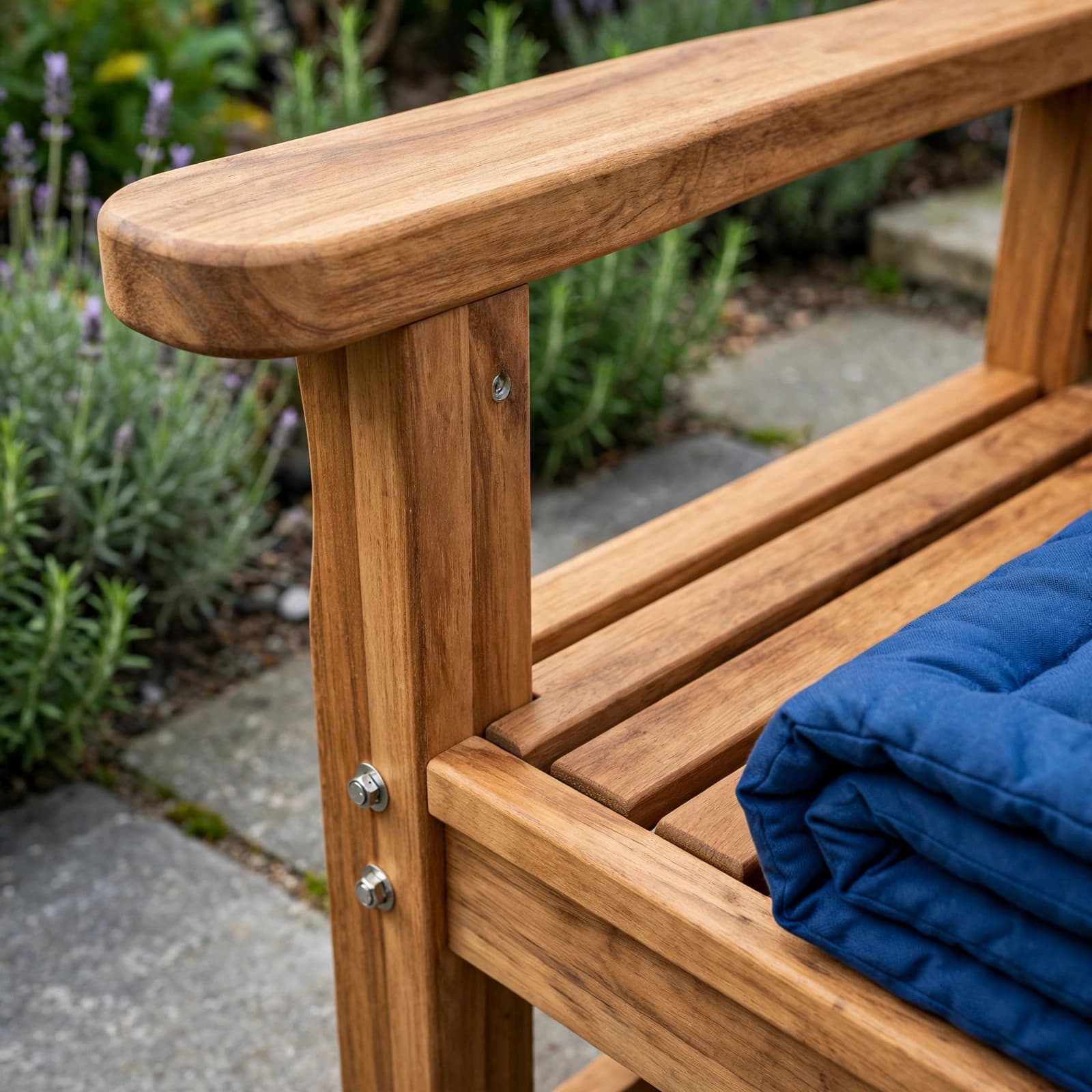 Wooden Garden Seats: A Practical UK Buyer's Guide 2 Close view of a timber garden seat with slats, rounded armrest, and metal fixings.