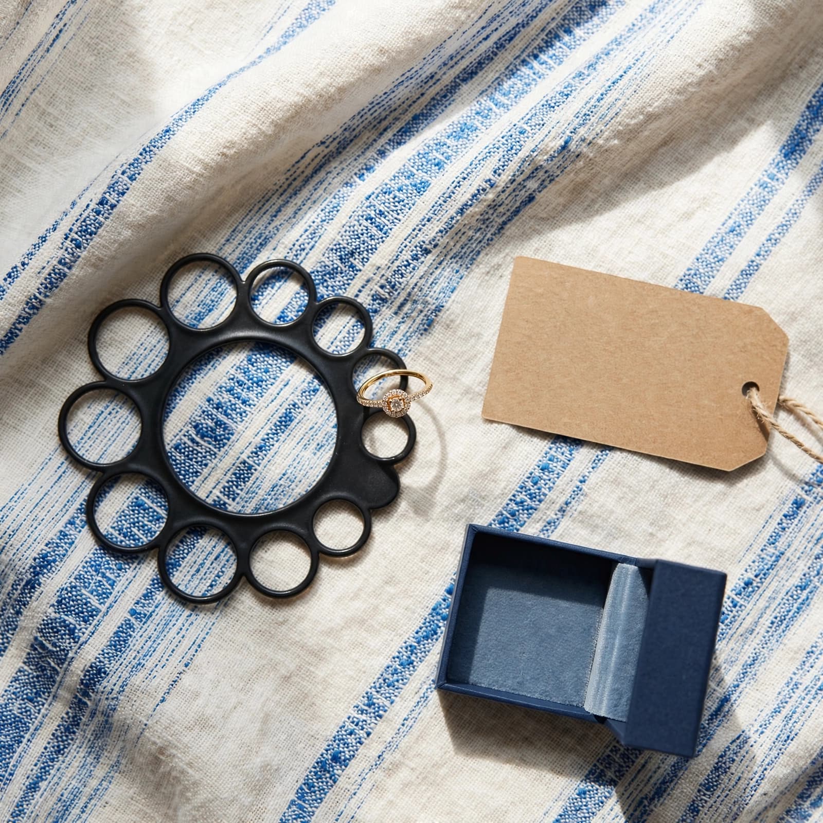Promise Ring Buying Guide: Meaning, Fit and Value 3 A promise ring sits beside a sizing gauge, jewelry box, and blank parcel card.